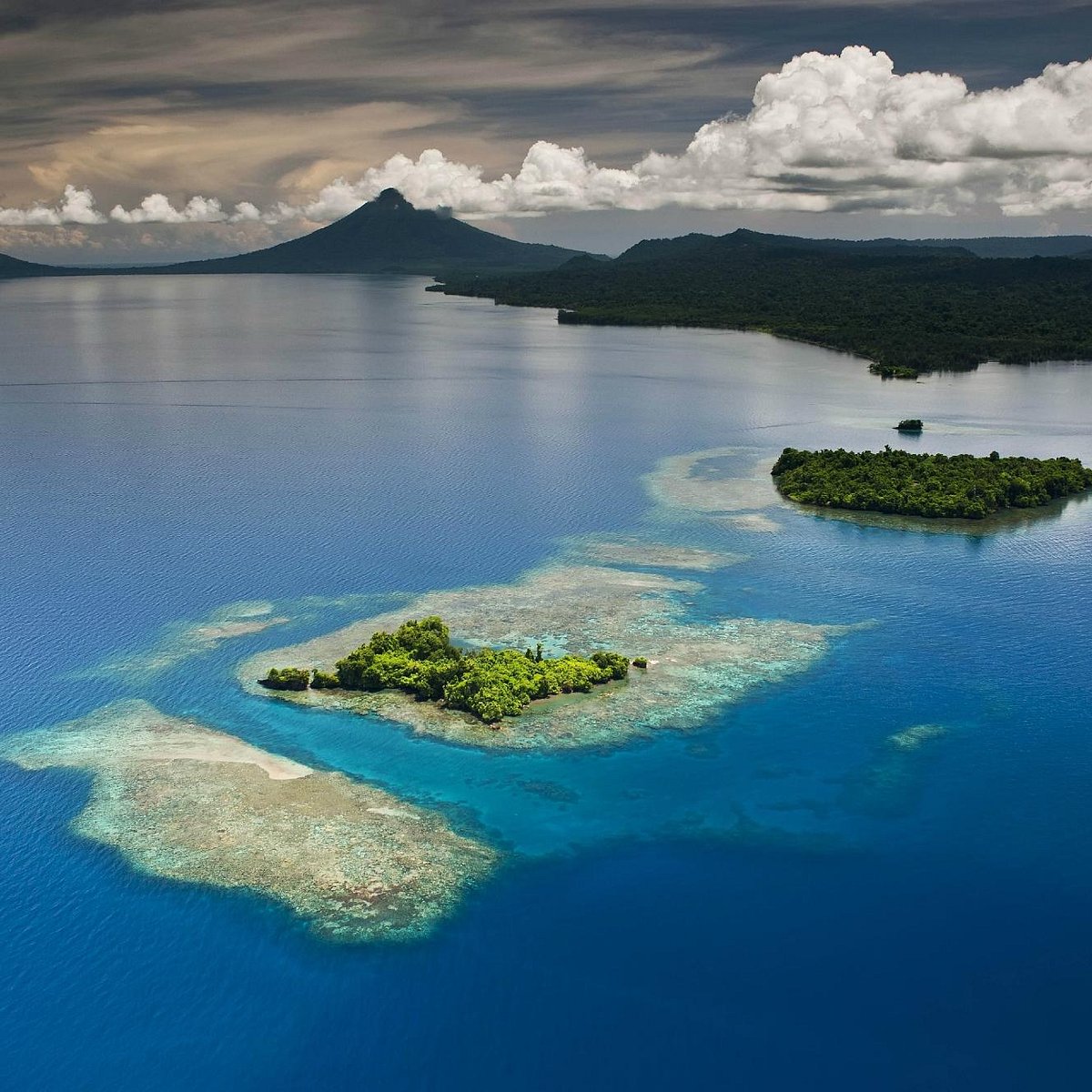 Aerial view of volcanic islands and reef in Papua New Guinea